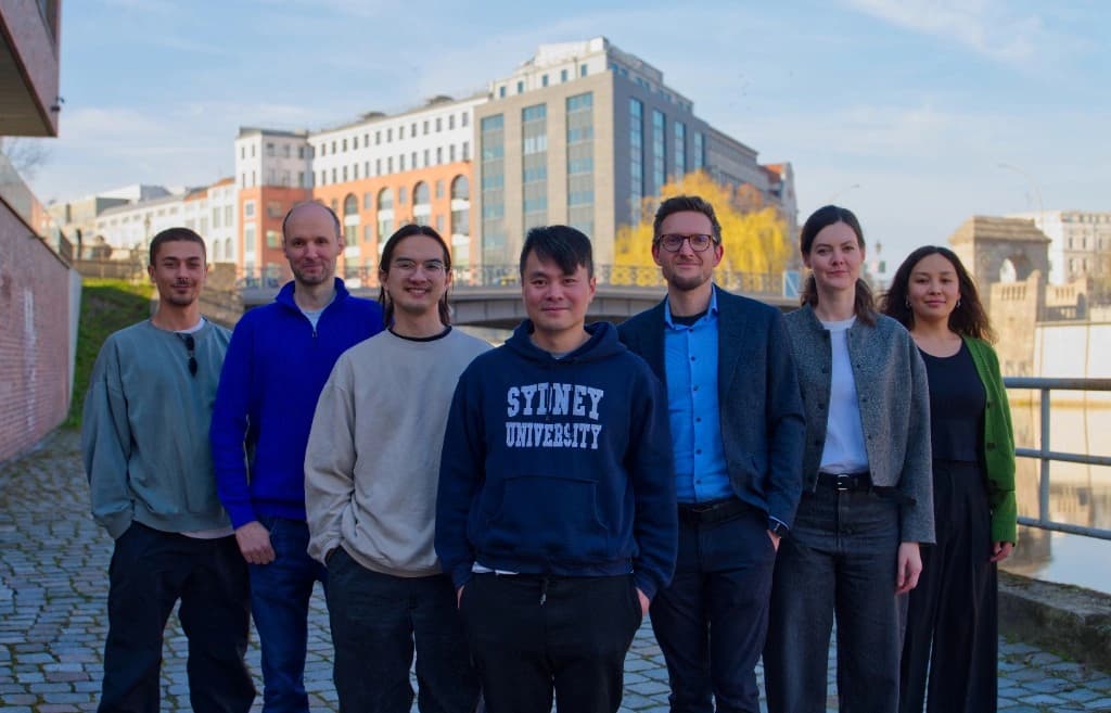 The DATANOMIQ team — seven colleagues standing together outdoors in Berlin.
